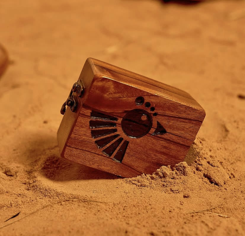 The JL ankyem wooden box, a hand-carved walnut case with an Iroko finish and detailed surface carvings, by Phyll Quahsey.